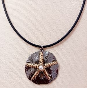 Gold and Silver Starfish Choker Pendant With Pearl Accent. 16" Rubber Cord.